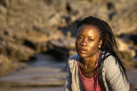 black woman looking at the camera while stretchingの写真素材