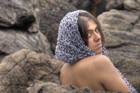 white woman covering herself with a scarfの写真素材