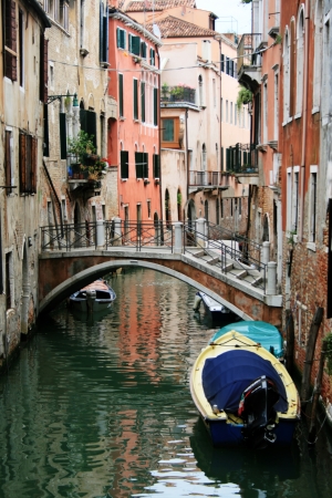 venice canal crossed by a bridgeの写真素材