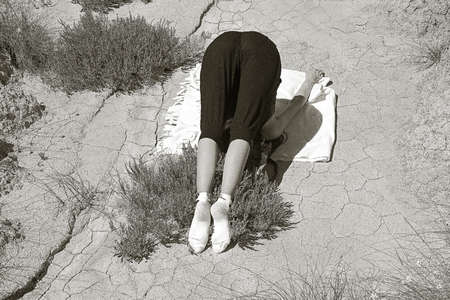 pretty girl doing yoga in the desert