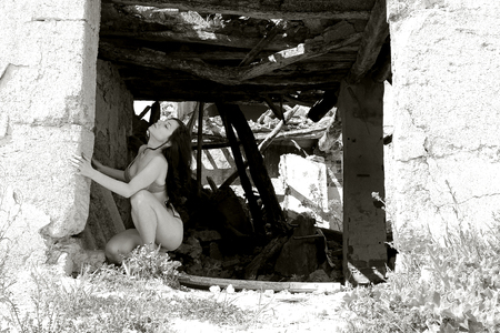 pretty girl posing in ruined townの写真素材