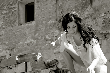 pretty girl posing in ruined townの写真素材