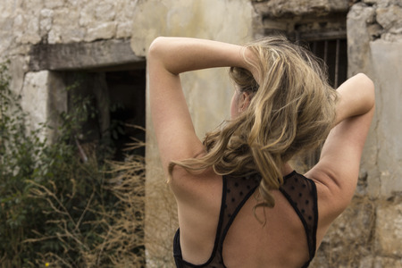 pretty girl posing in ruined townの写真素材