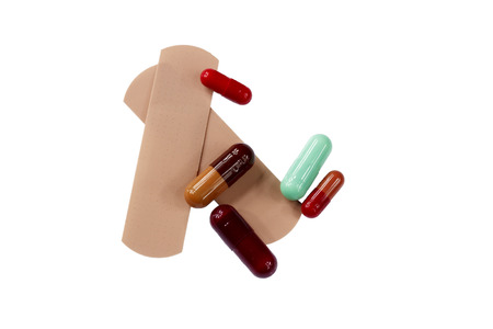 isolated adhesive band in white background with some pillsの写真素材