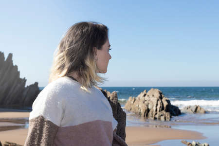 portrait of young woman in a wool sweater outdoors