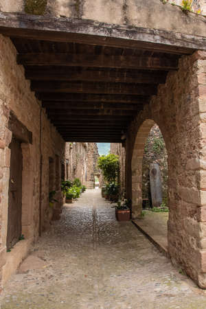 arched street in the medieval village of Santa Pau in Girona