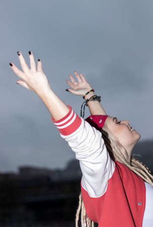woman with dreadlocks raising armsの写真素材