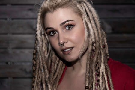 pretty blonde woman with confident dreadlocks looking at camera