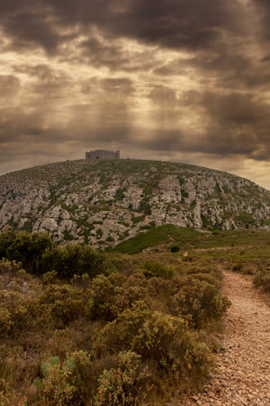 montgri castle on the costa brava in the north of spain a cloudy dayのeditorial素材