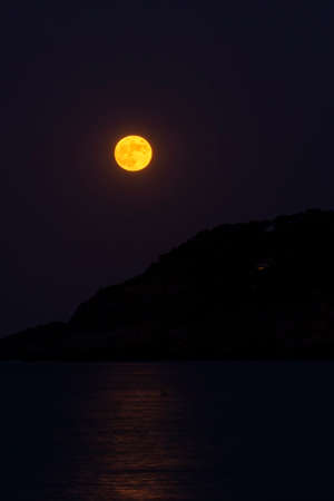 full moon on the coast of the mediterranean sea in the spanish costa bravaの写真素材