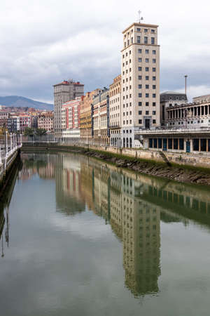 old building on the bank of the ria de bilbao in the north of spainの写真素材