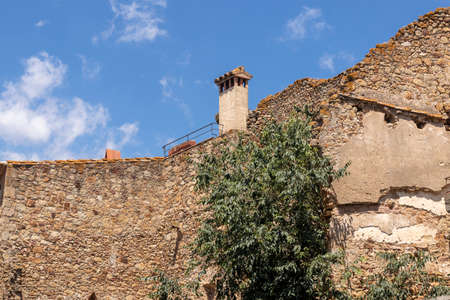 narrow stone street in the medieval town of pals on the costa brava on a sunny summer dayの写真素材