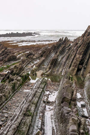 stratified rocks on the beach of sopelana in the basque countryの写真素材