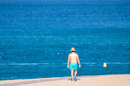 man walking on the beach in the mediterraneanの写真素材