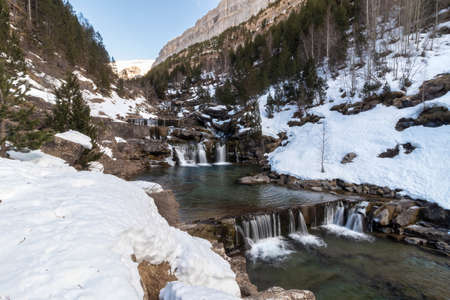 waterfall in ordesa national park in the spanish pyrenees in winterの写真素材