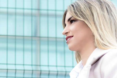 portrait of business woman in profile on the street