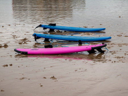 surfboards on the beach sand on a cloudy dayの写真素材