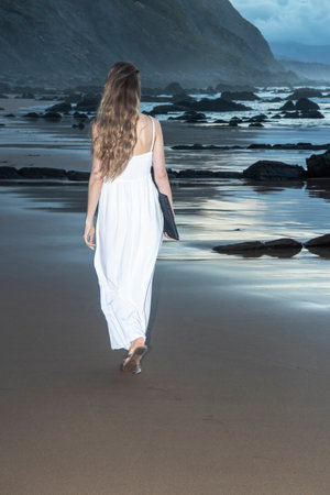 Young woman using laptop on a beach. freelance work conceptの写真素材