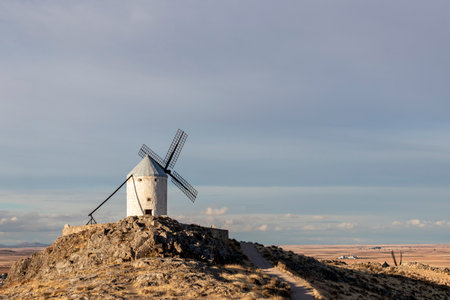 old windmills in the city of Consuegra Spain , on the route of the Don Quixote and Cervantes mills, at sunsetの写真素材