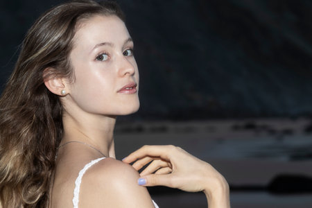 Beautiful young blond woman outdoors portrait near the seaの写真素材