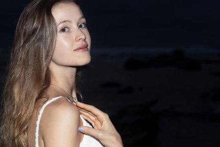 Beautiful young blond woman outdoors portrait near the seaの写真素材