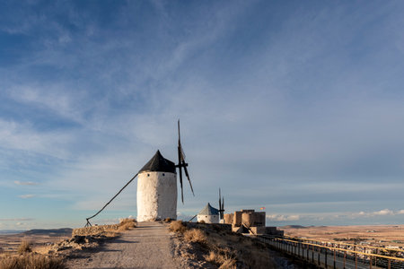 Windmills on hill at sunset in Consuegra, Mancha, Spainの写真素材