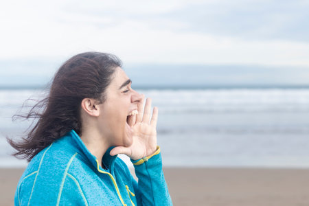 screaming woman on the beach, copy space, left sideの写真素材