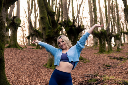 Free Spirit: Blonde Woman Celebrating Life in the Rustling Leavesの写真素材