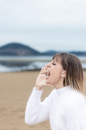 Breaking Point: Woman Expresses Frustration and Stress with a Shout in the Open Airの写真素材