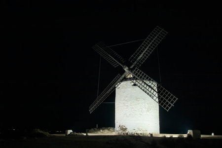 Illuminated History: Windmills of Consuegra in Toledo Shine at Nightの写真素材
