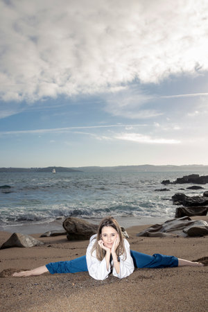 A Perfect Escape: Yoga on the Beach with a Stunning Blonde Womanの写真素材