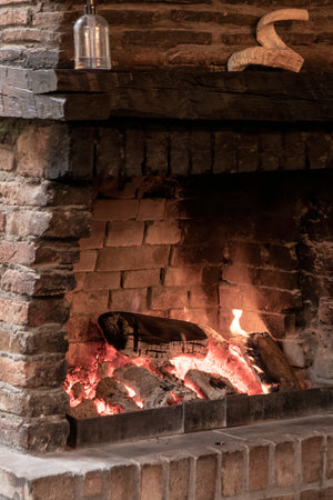 Rustic Charm: Cozy Fireplace Illuminates a Country Interiorの写真素材