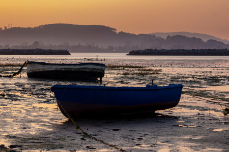 Boats and Bridge in the Orange Sky of Laredo in spainの写真素材