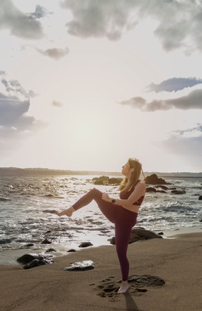 Coastal Martial Arts: Witness the Dynamic Grace as a Young Woman Executes a Taekwondo Kickの写真素材