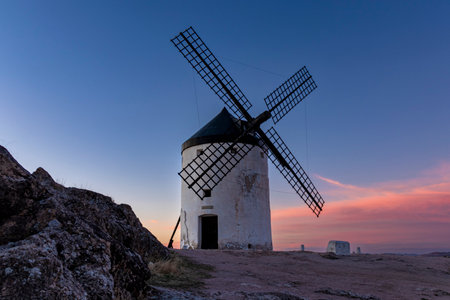 Captivating Views of the Consuegra Windmills in the Golden Hourの写真素材