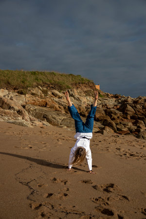 Coastal Fitness with Taekwondo: Beachside Martial Arts Performance Filled with Power and Graceの写真素材