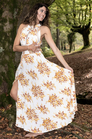 Exploring Woodlands with a Happy, Attractive Woman in a Flowing Dressの写真素材