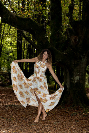 Summer Dreams: Woman's Whimsical Journey through the Enchanting Beech Forestの写真素材