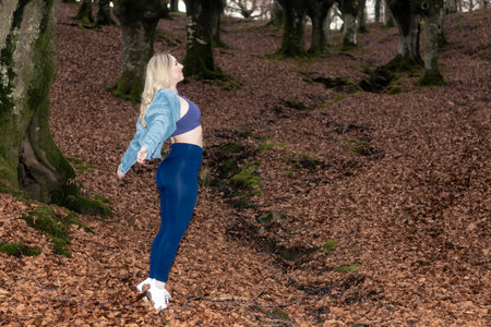 Beauty: Embracing Autumn Serenity with Deep Breaths in a Forest Retreatの写真素材