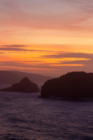 Enchanting Sunset at San Juan de Gaztelugatxe: Majestic Coastal Haven bathed in Twilightの写真素材