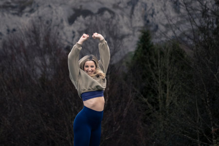 Golden Jubilation: Blonde Beauty Leaps with Joy in the Enchanting Autumn Beech Forestの写真素材