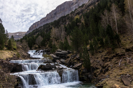 Tranquility and Adventure Merge at the Enchanting Soaso Falls in Ordesaの写真素材
