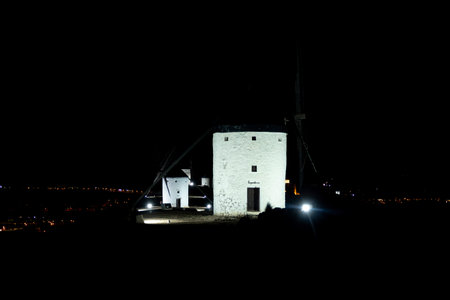 Enchanting Nightscapes Windmills of Consuegra Illuminated Under the Starlit Skyの写真素材