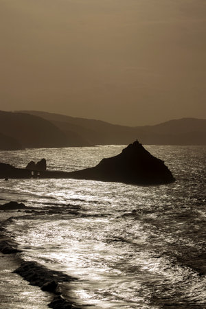Twilight at San Juan de Gaztelugatxe: Captivating Coastal Beauty under the Setting Sunの写真素材
