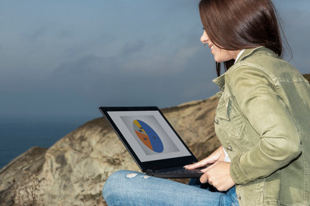 Seamless Outdoor Telecommuting: Woman's Laptop Workstation Amidst Nature's Serenityの写真素材