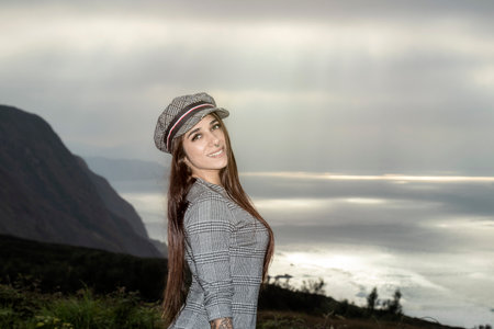 Urban Elegance: Confident Young Brunette Flaunting Edgy Style with a Chic Plaid Capの写真素材