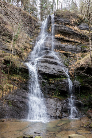 UGUNA Waterfall's Majestic Descent Amidst Lush Vizcayan Greeneryの写真素材