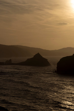 Captivating Views of San Juan de Gaztelugatxe as Day Transforms to Nightの素材