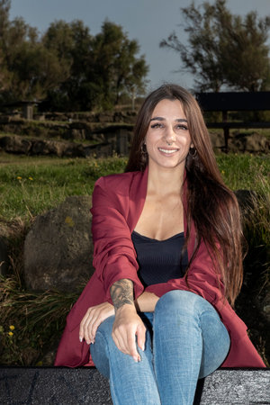 Serene Beauty: Thoughtful Brunette with Arm Tattoo Finds Peace in Contemplative Solitudeの写真素材