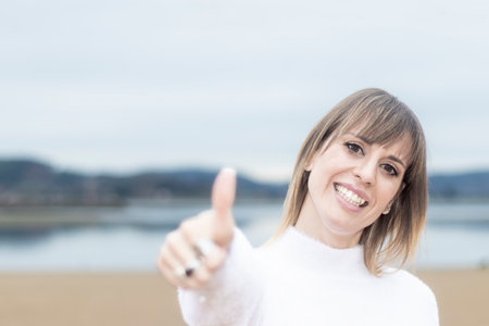 Embodying Positivity: Beautiful Woman s Joyful Moment on the Beachの写真素材
